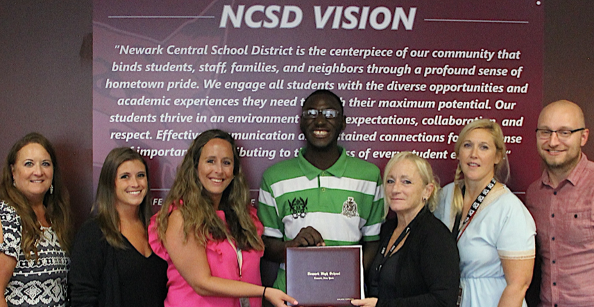Malachi Graduating with Newark High School Staff