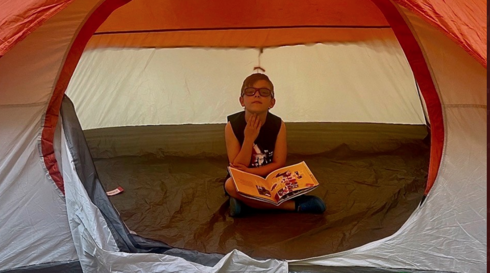 Pictured: Perkins student reading in a tent