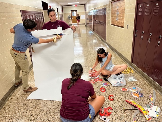 Pictured: Staff of Kelley School Preparing Welcoming Signs for Students